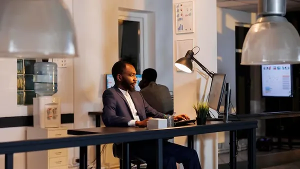 African business colleagues reviewing over documents in an office — an article about online business ideas for Nigerians