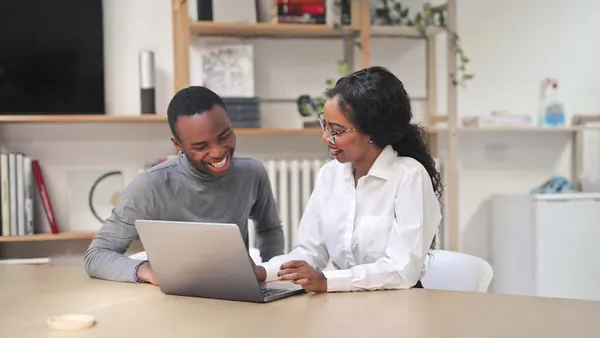 African couple working in an office — an article about AI chatbot development cost in Nigeria