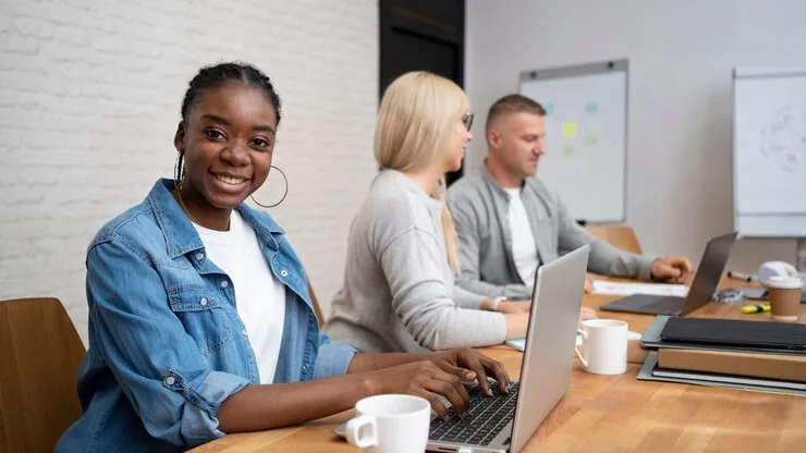 Business colleagues working in an office — an article about AI customer service for Nigerian e-commerce