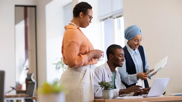 Business colleagues working in an office — an article about AI for customer acquisition in Nigeria