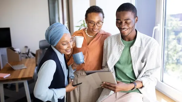 Business colleagues working in an office — an article about AI for customer loyalty in Nigeria