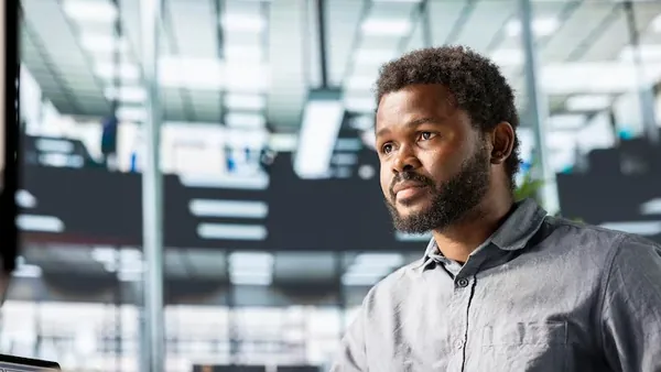 An African businessman working in an office — an article about AI for Nigerian agriculture