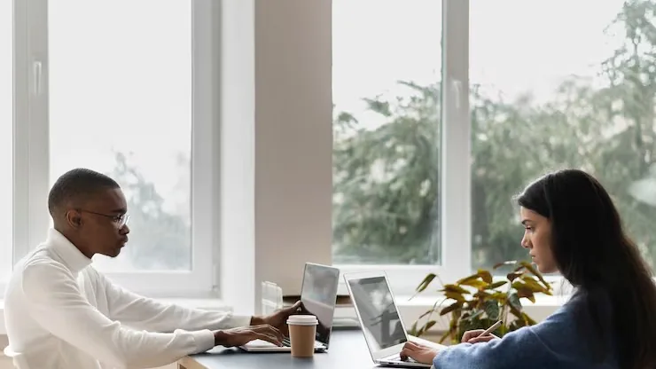 Business colleagues working in an office — an article about AI for Nigerian fashion businesses