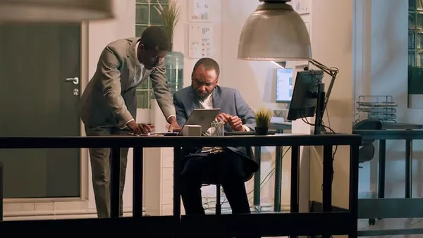 Business colleagues working in an office — an article about AI for Nigerian hospitality