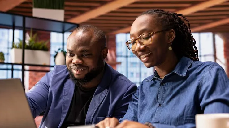 An African businesswoman working over documents in an office — an article about AI for Nigerian manufacturing