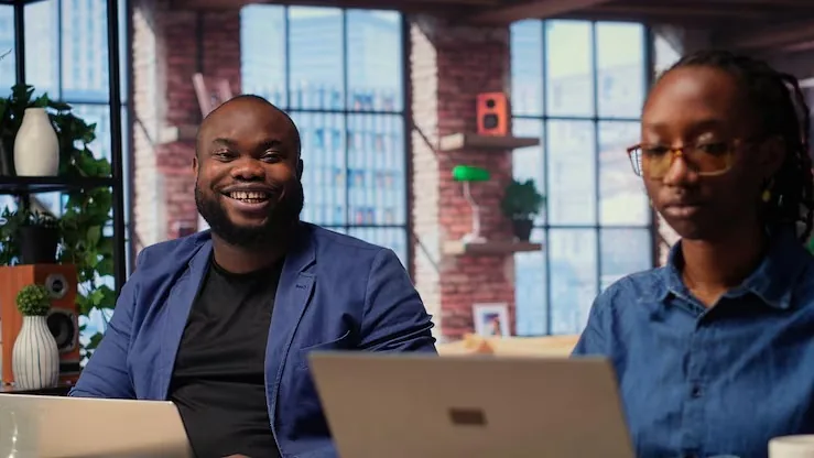 African couple working in an office — an article about AI for Nigerian real estate