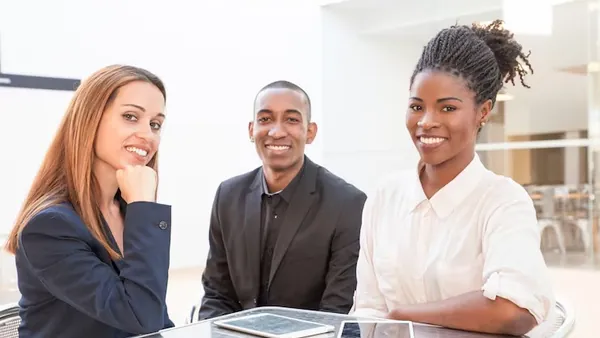 Business colleagues at work in a cafe — an article about AI legal assistants for Nigerian law firms