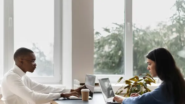 Business colleagues working in an office — an article about AI social media management for Nigerian businesses
