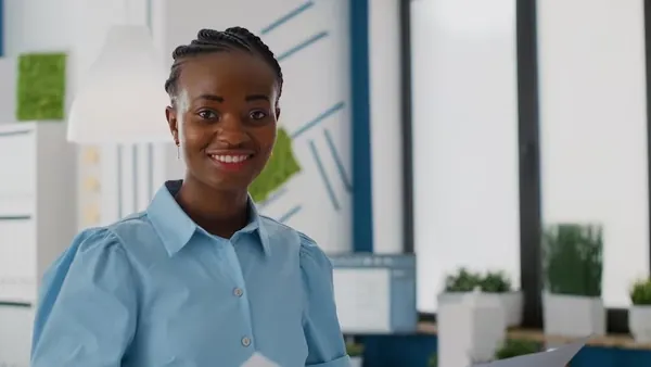 An African businesswoman working in an office — an article about AI website development cost in Nigeria