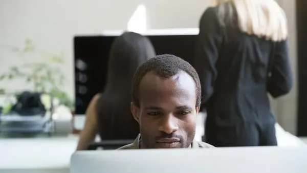 An African businessman working in an office — an article about AI WhatsApp automation for Nigerian businesses