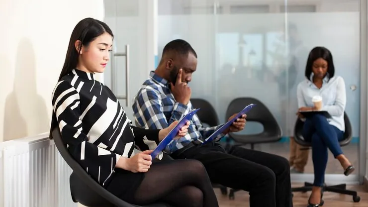 Business colleagues working in an office — an article about app maintenance cost in Nigeria