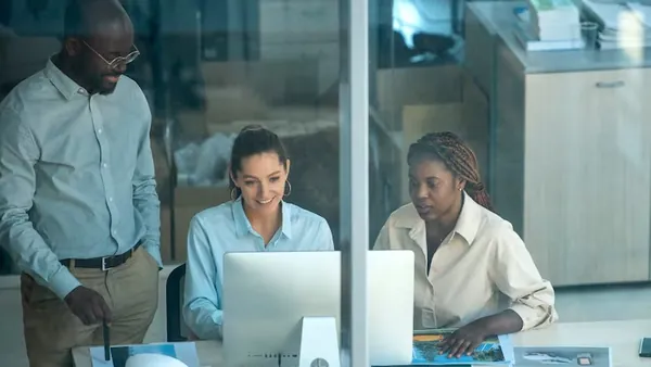 Business colleagues working in an office — an article about automating customer follow-up in Nigeria