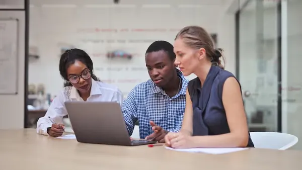 Business colleagues working in an office — an article about HR automation Nigeria