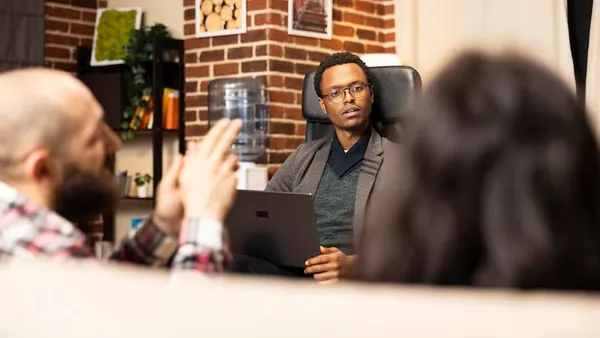 African couple working on a laptop in an office — an article about invoice automation Nigeria