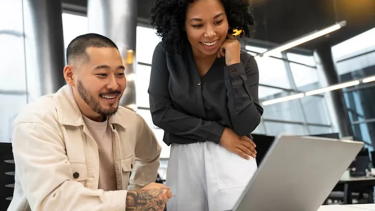 Business colleagues working in an office — an article about best AI tools for Nigerian marketing teams