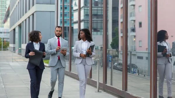 Business colleagues working in an office — an article about manufacturing automation ideas Nigeria
