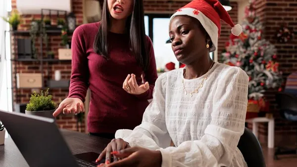 Business colleagues working on a laptop in an office — an article about real estate automation ideas Nigeria