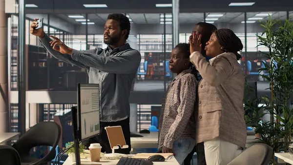 African business colleagues taking notes in an office — an article about can AI replace employees in Nigeria