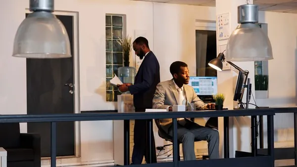 An African businessman reviewing over documents in an office — an article about client portals for Nigerian law firms