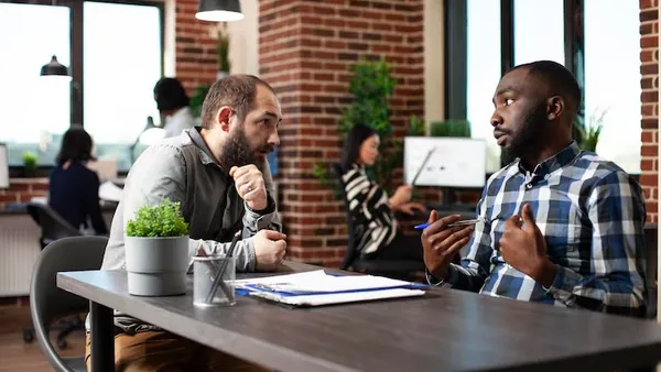 Business colleagues working in an office — an article about AI and software buying guide Nigeria