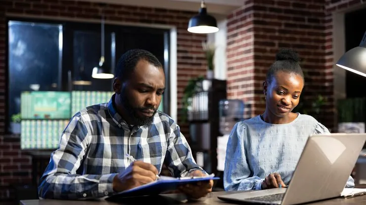 Business colleagues in a meeting in an office — an article about CRM for Nigerian real estate companies