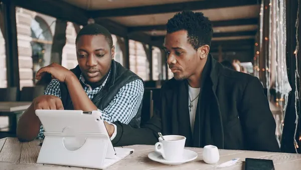 A businessman working in a cafe — an article about CRM integration services Nigeria