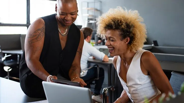 Business colleagues working in an office — an article about CRM vs spreadsheet for Nigerian businesses
