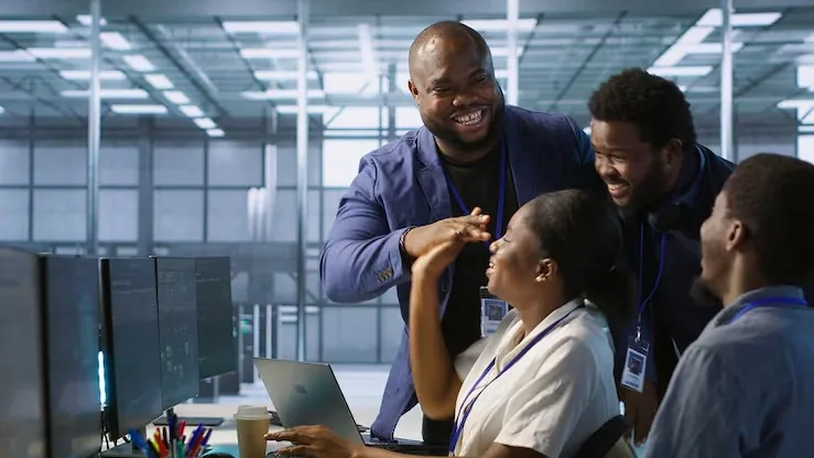 Business colleagues working over documents in an office — an article about customer service KPIs for Nigerian businesses