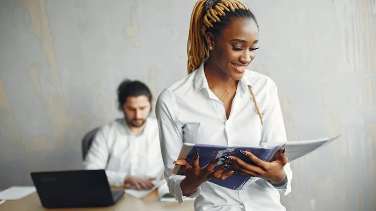 An African businesswoman working on a laptop in an office — an article about delivery app development in Nigeria