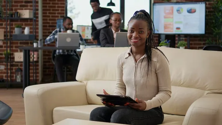 A businesswoman working with a tablet in an office — an article about digital marketing for Nigerian hotels