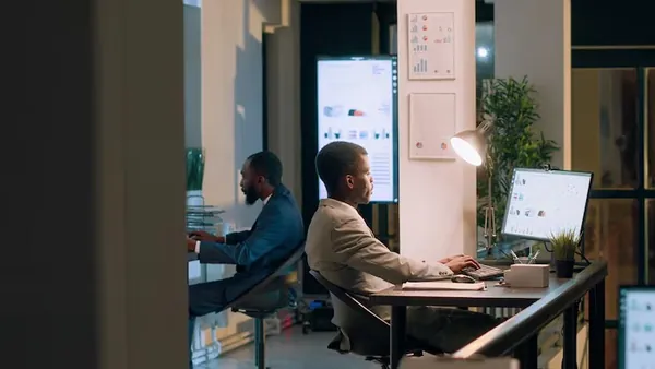Business colleagues reviewing in an office — an article about digital transformation cost in Nigeria