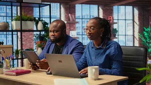 An African businesswoman working in an office — an article about do Nigerian SMEs need a mobile app