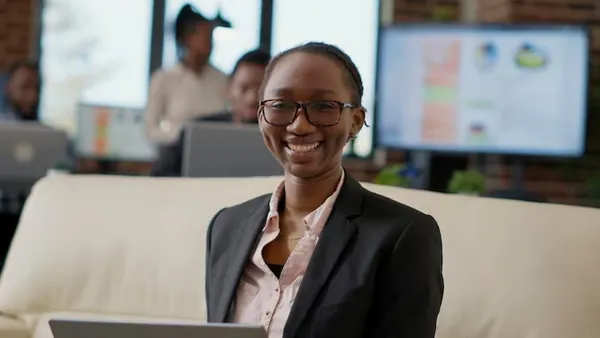 A businesswoman in a meeting at a computer in an office — an article about do small businesses in Nigeria need a website
