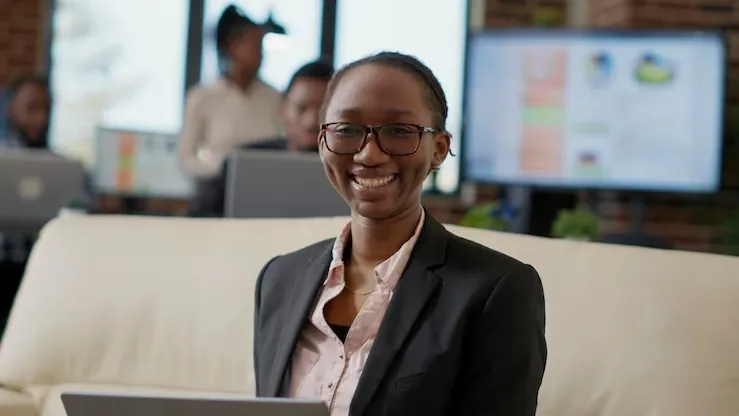 A businesswoman in a meeting at a computer in an office — an article about do small businesses in Nigeria need a website