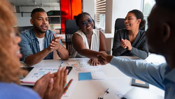 Business colleagues working in an office — an article about e-commerce website development in Nigeria