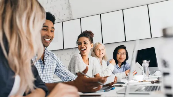 Business colleagues in a meeting in an office — an article about freelancer vs agency app development