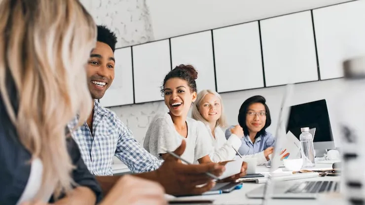 Business colleagues in a meeting in an office — an article about freelancer vs agency app development