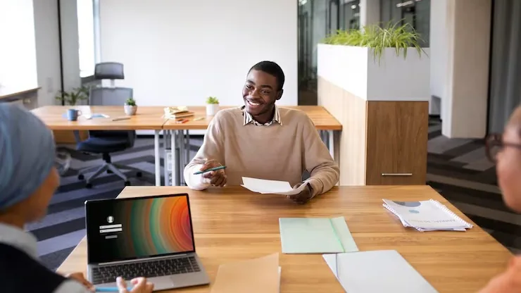 A businessman in a meeting in an office — an article about freelancer vs agency website development