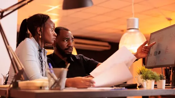 African business colleagues in a meeting at a computer in an office — an article about Google Analytics for Nigerian