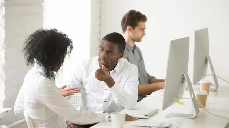 African business colleagues in a meeting in an office — an article about hotel booking app development in Nigeria