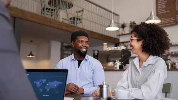 Business colleagues working in an office — an article about hotel management software in Nigeria