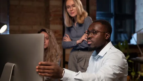 Business colleagues working in an office — an article about hotel website design in Nigeria
