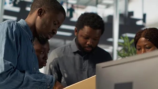 African business colleagues working in an office — how automation reduces business costs in Nigeria
