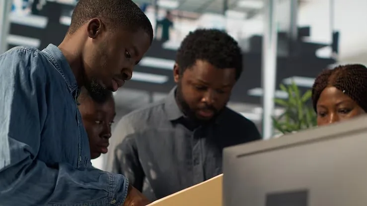 African business colleagues working in an office — how automation reduces business costs in Nigeria