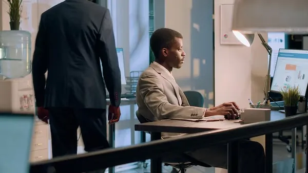 African business colleagues working at a computer in an office — how long does SEO take