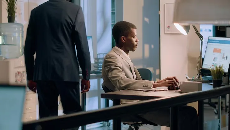 African business colleagues working at a computer in an office — how long does SEO take