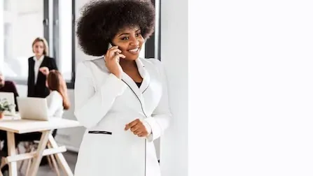 A businesswoman on a call on a phone in an office — an article about mobile apps improve customer service