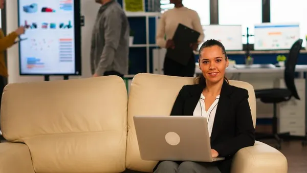 Business colleagues reviewing at a computer at home — an article about professional website cost in Lagos