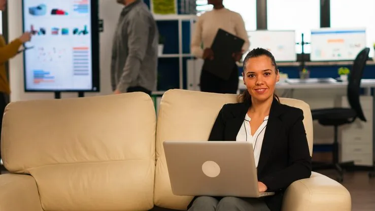Business colleagues reviewing at a computer at home — an article about professional website cost in Lagos