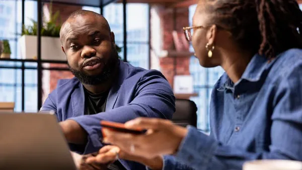 African business colleagues working in an office — an article about AI integration cost in Nigeria